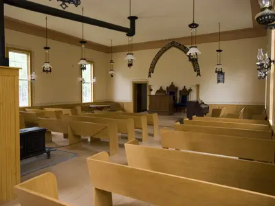 inside of chapel with pews facing alter