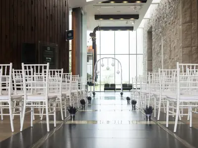 white chairs set on either side of an aisle facing an arch inside the museum