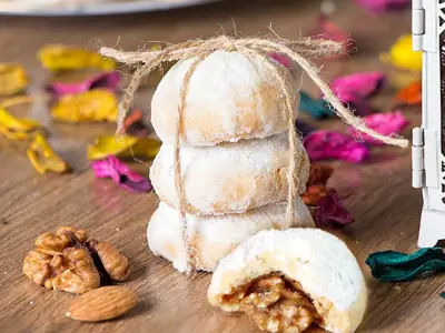 cookies stacked and wrapped in string surrounded by pink, yellow and blue confetti