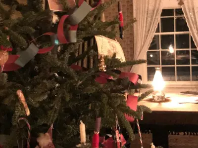 Christmas tree decorated in paper chains and a lit lantern
