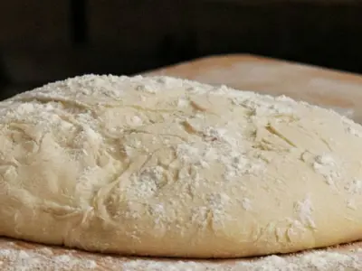 round lump of dough covered in flour