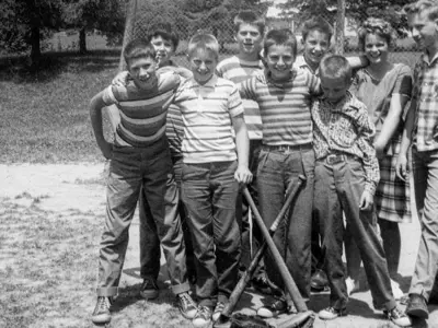 black and white photo of group of young kids with baseball equipment