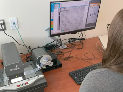 looking over the shoulder of a woman who is using a computer