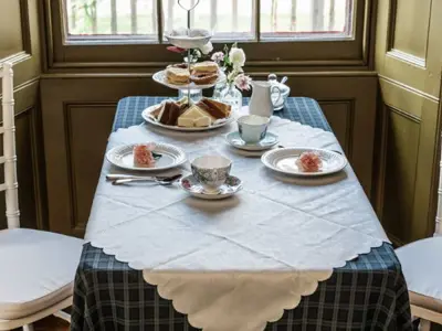 table set for tea with a chair on either side of table