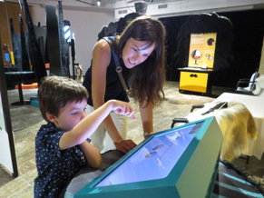 mom and young boy looking at exhibit activity